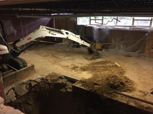 Digger moves dirt around room.
